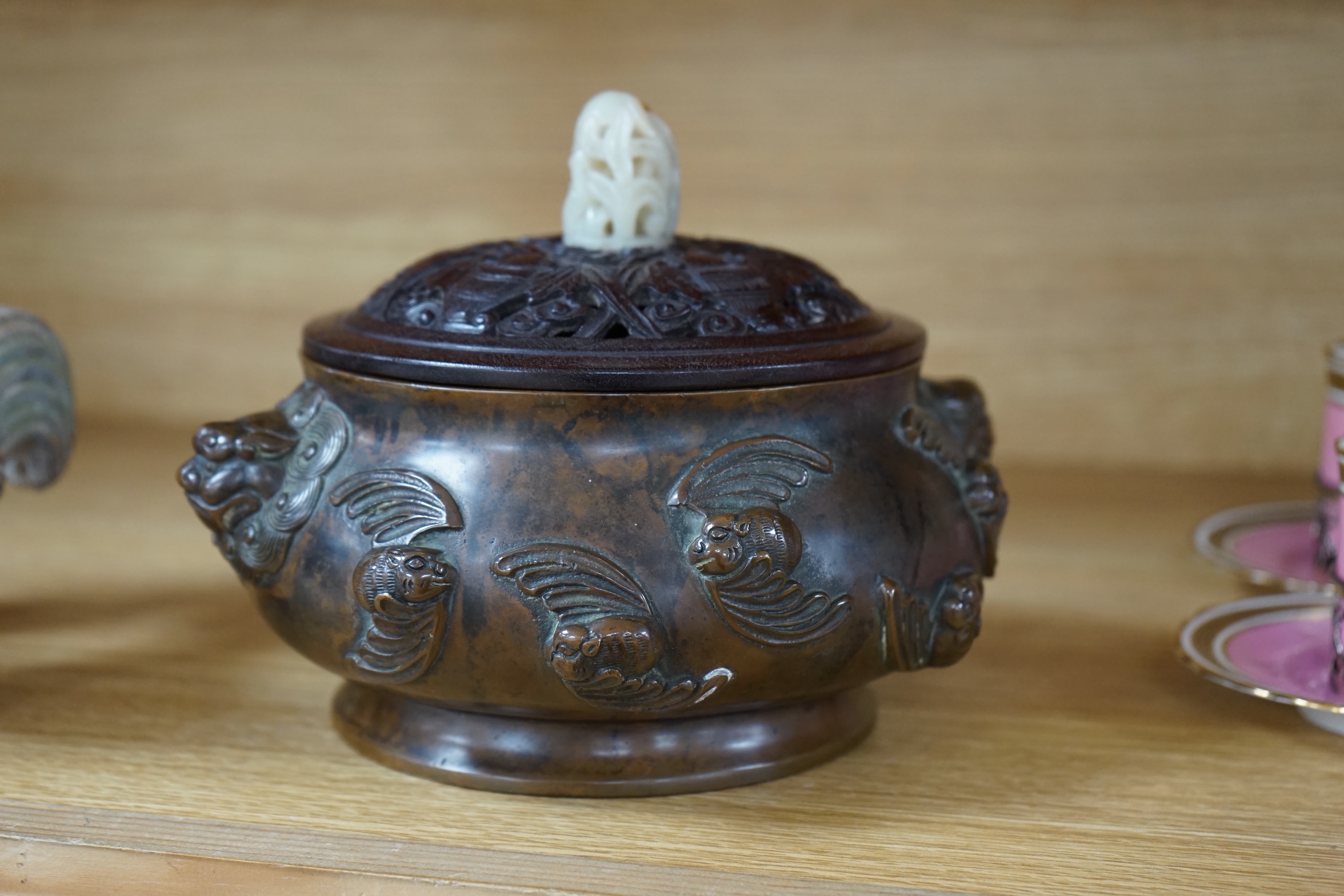 A Chinese bronze censer, with carved wooden cover and jade finial, 17cm high. Condition - good